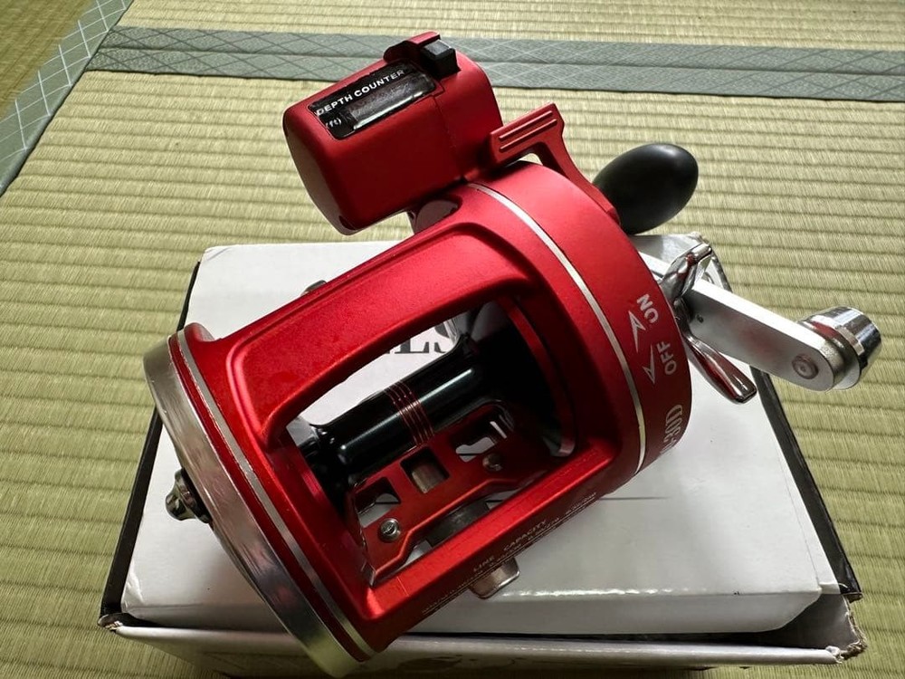 Unused bait reel with depth counter red