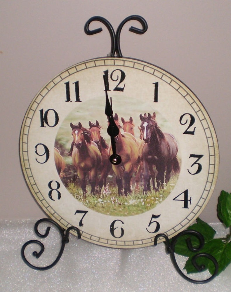 ~~GALLOPING THOROUGHBRED HORSES CLOCK MOUNTED ON BLACK SCROLL STAND~~