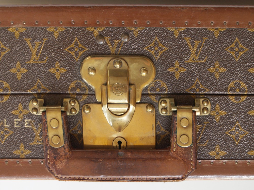 Louis Vuitton monogram suitcase trunk open by center, square handle.