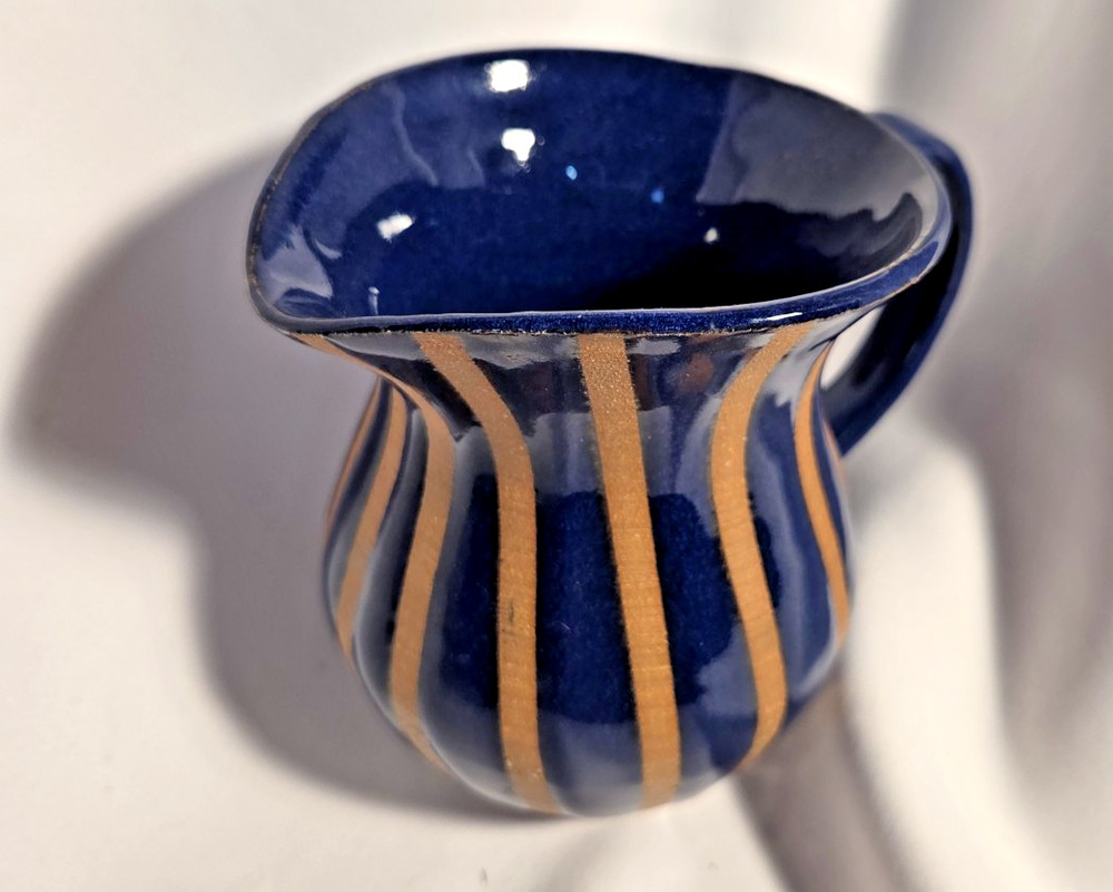 Pottery pitcher 2 toned with handle.