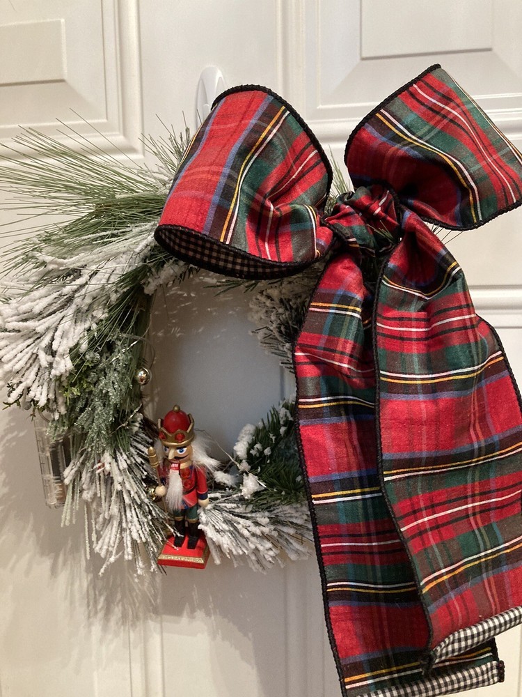 The Nutcracker Wreath With A Red And Green Ribbon