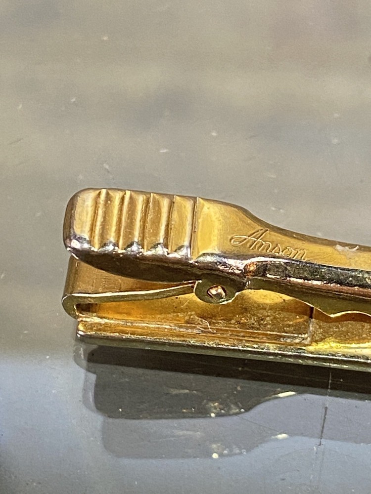 Two Tie Clips, One Marked Anson
