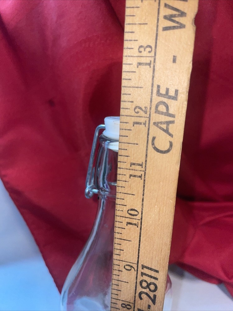 Clear bottle with latch lid- bottom has a b on it