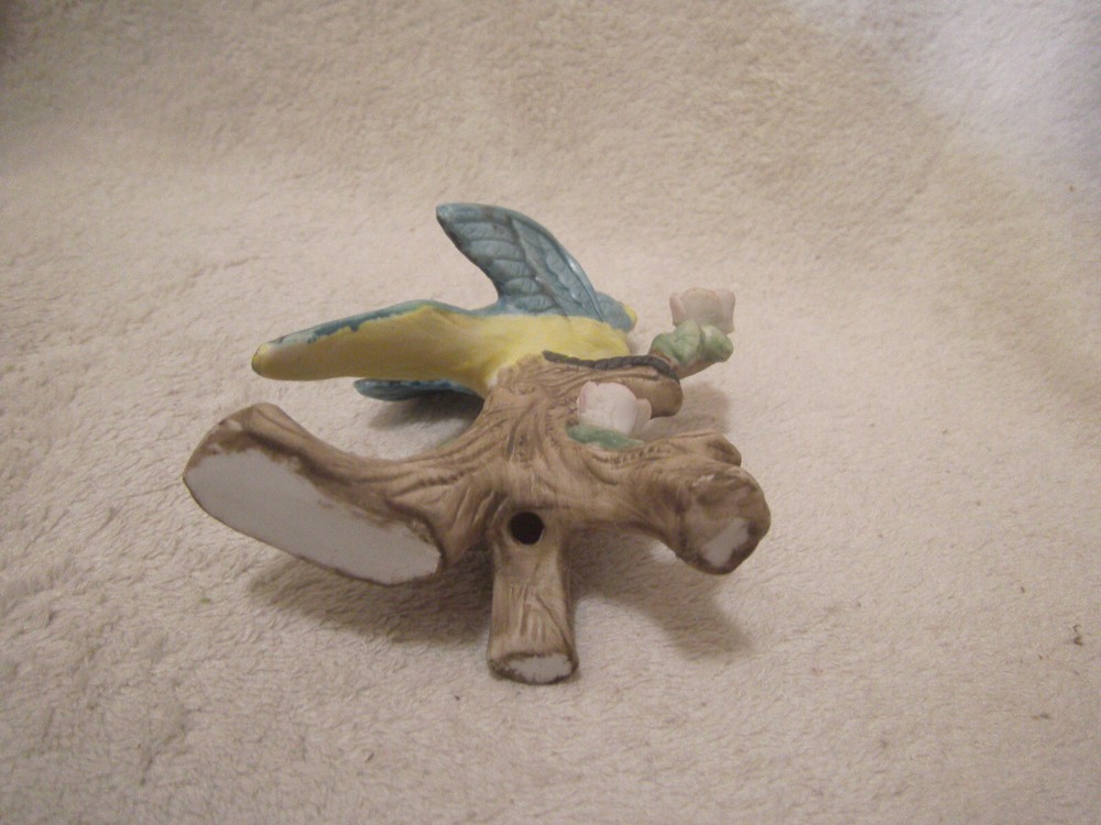 Blue ceramic parrot on tree branch 4 1/2 inches tall