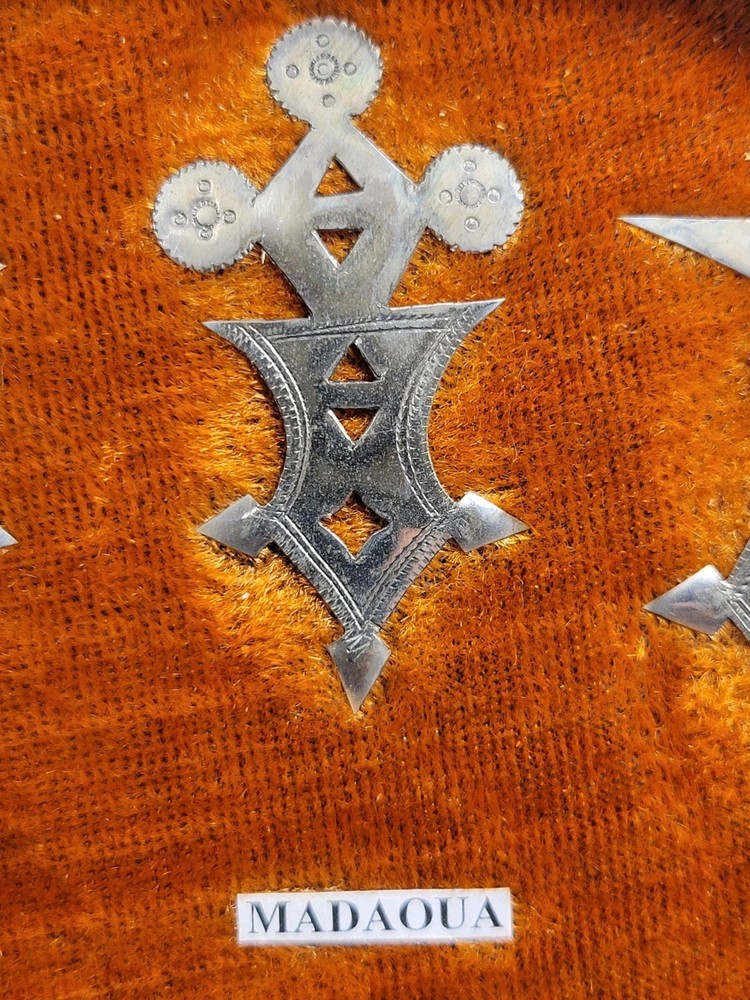 Collection of Hand-tooled Tin Badges