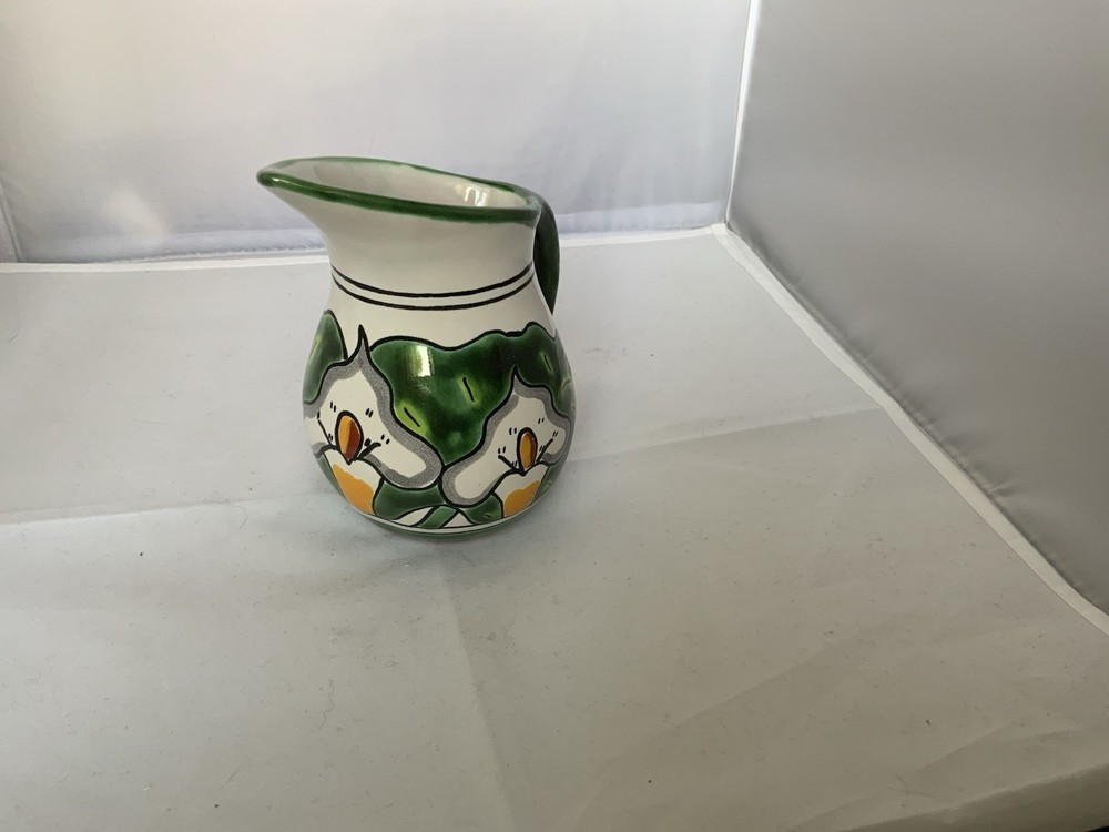 Small ceramic pitcher with floral design Signed