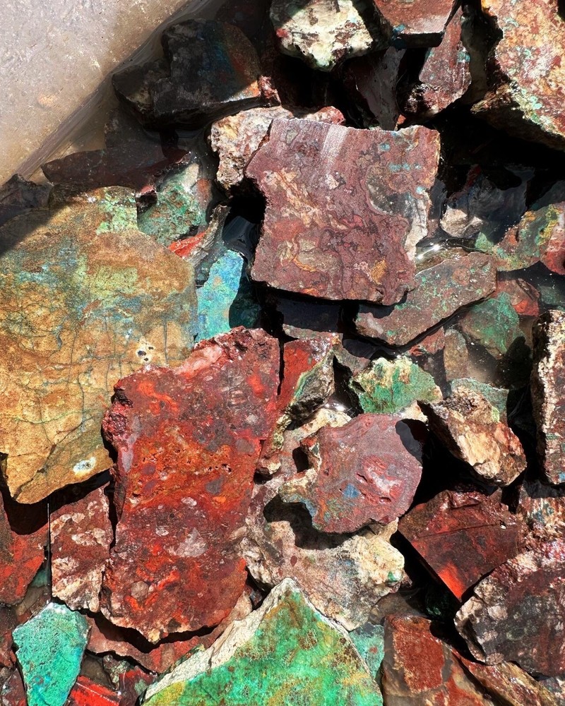 Apache gem Chrysocolla large parcel of slabs and cutter stones.