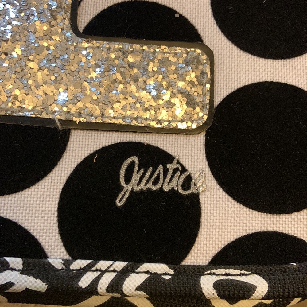 Justice brand binder with LOVE black dots.