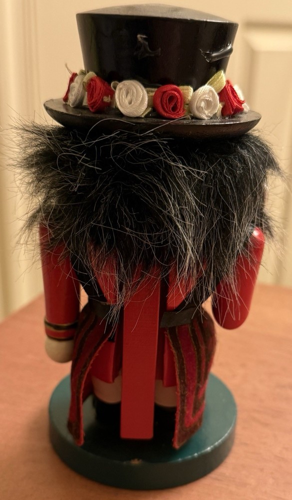 RED STUBBY MULTICOLOR WOODEN NUTCRACKER W/FLOWERED HAT - ENGLISH