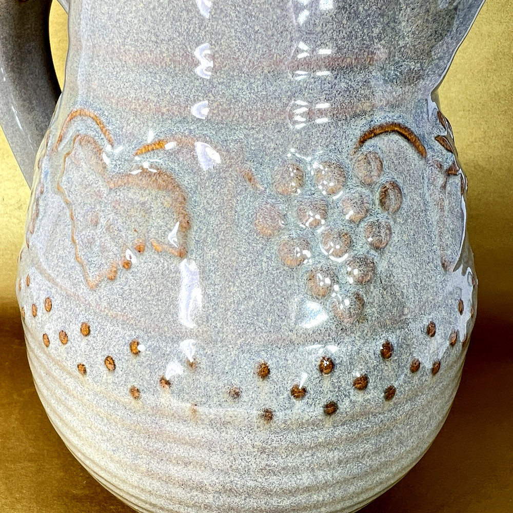 Unbranded Glazed Stoneware Pitcher embossed with fruit and glazed inside