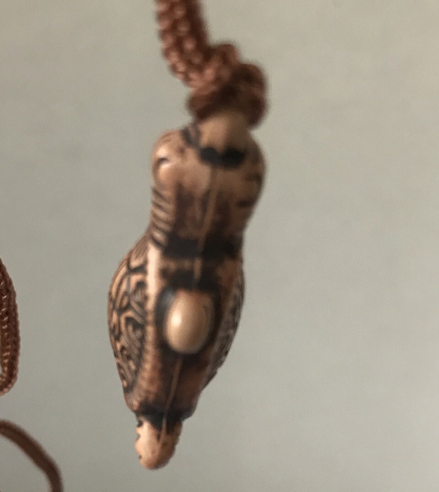 Resin turtle pendant with adjustable rope chain.