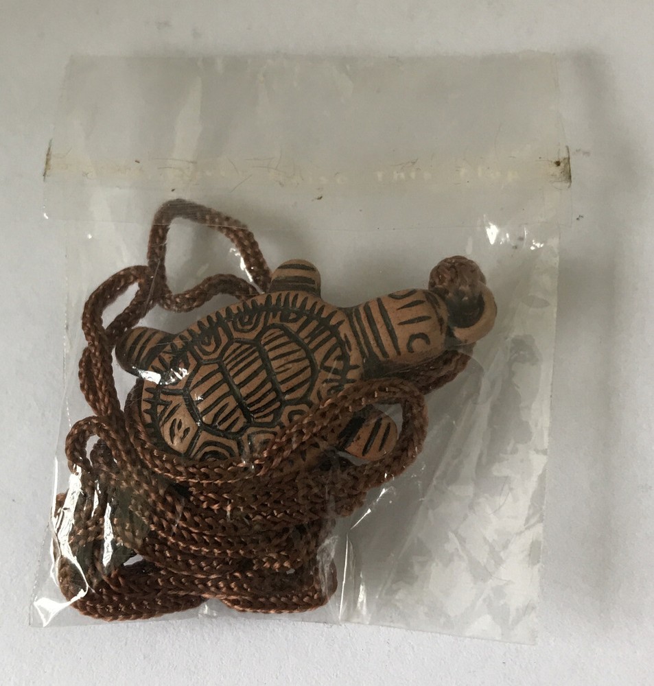 Resin turtle pendant with adjustable rope chain.