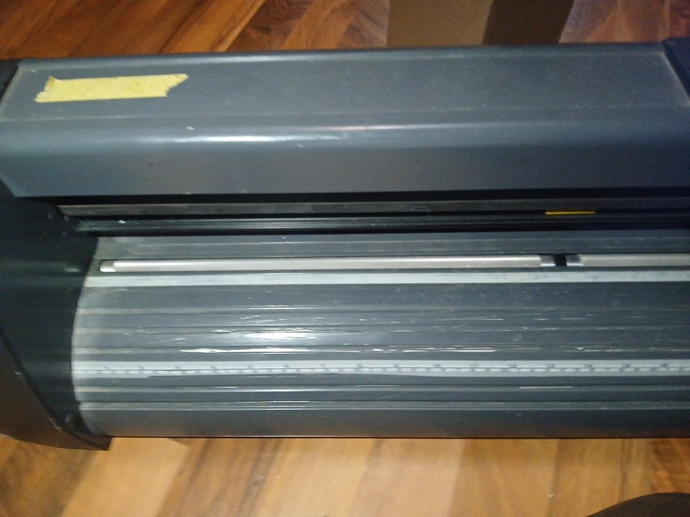 computer-controlled vinyl cutter machine Some Vinyl Material And Two Discs