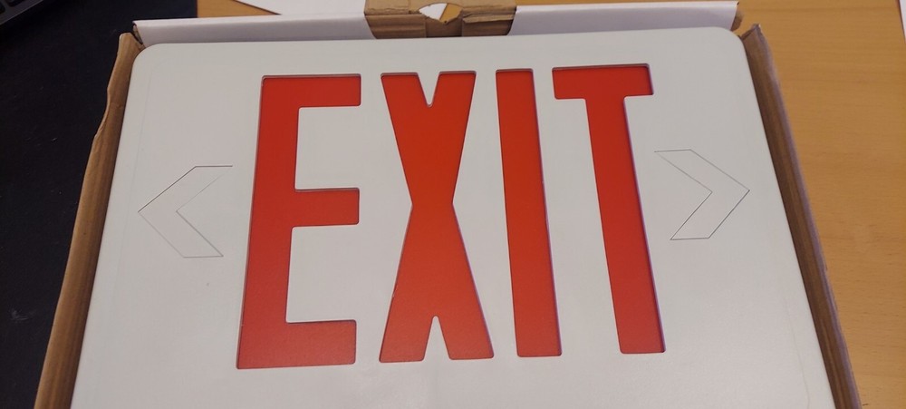 Thermoplastic Emergency EXIT sign. White with red lettering.
