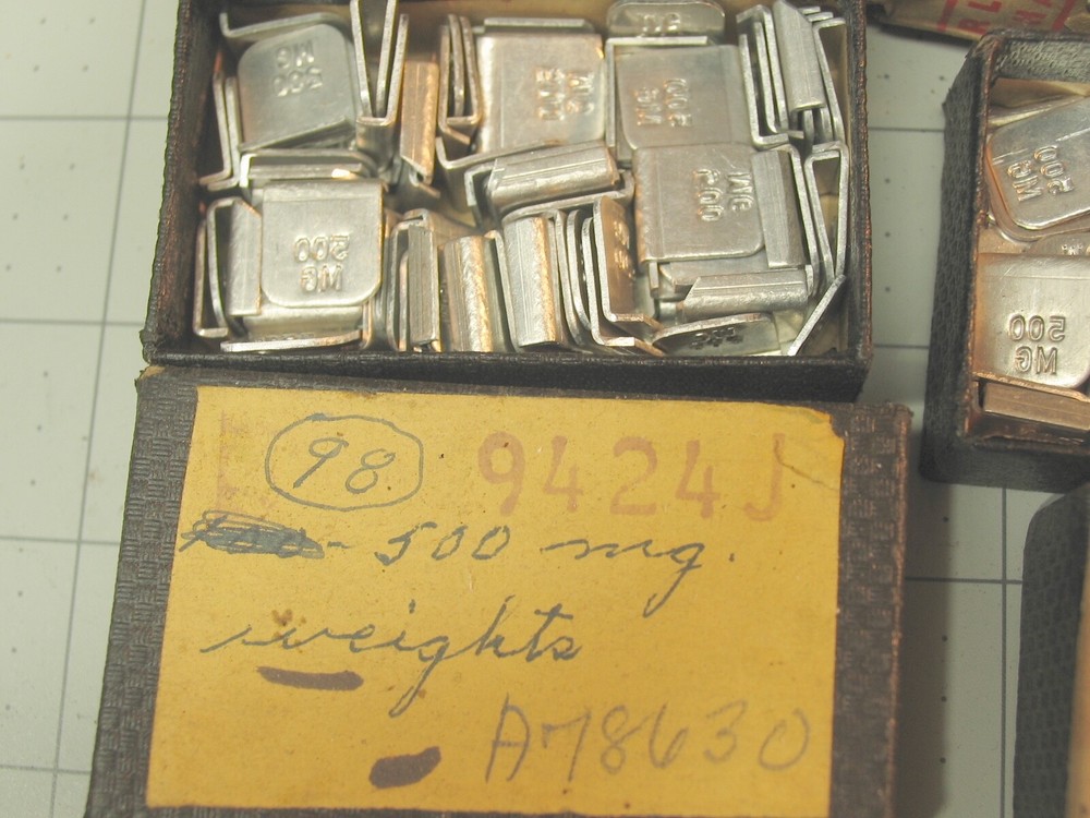 Collection of tiny marked weights 5mg-500mg.