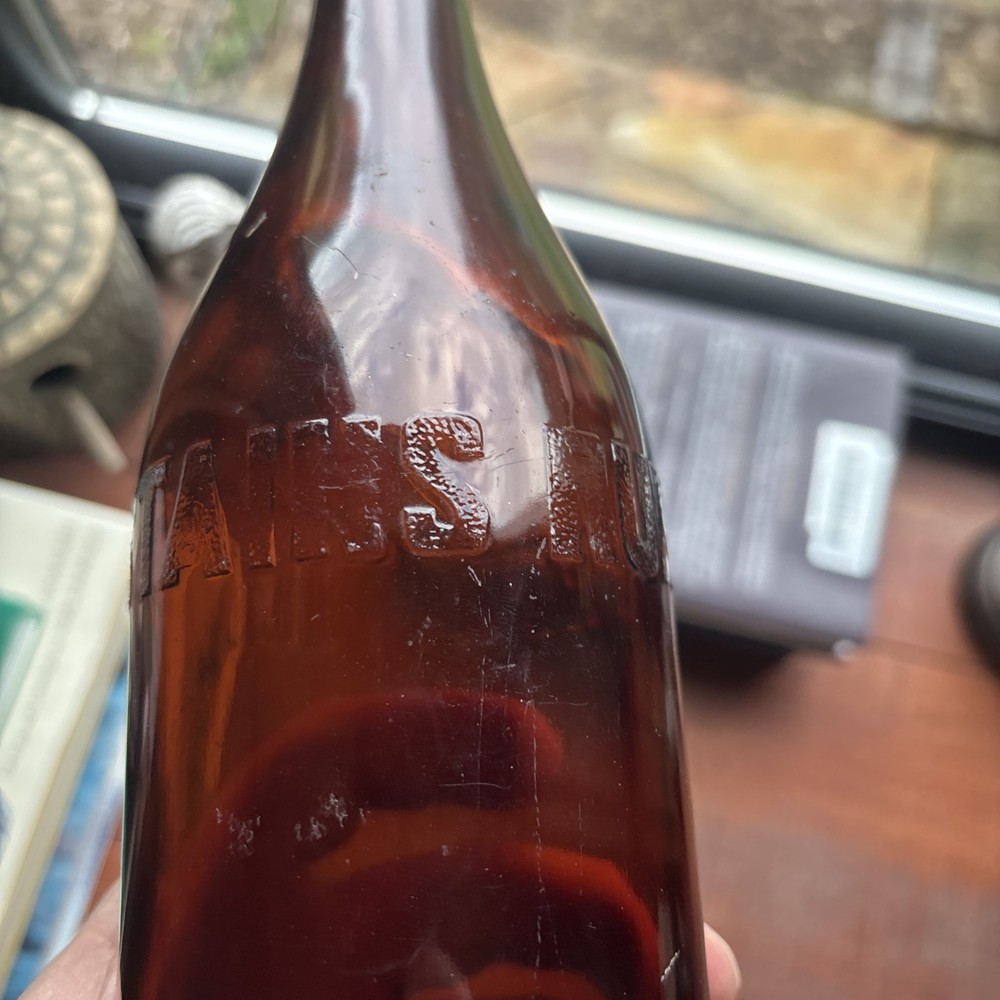 Stains Run From 101 Amber Embossed Bottle