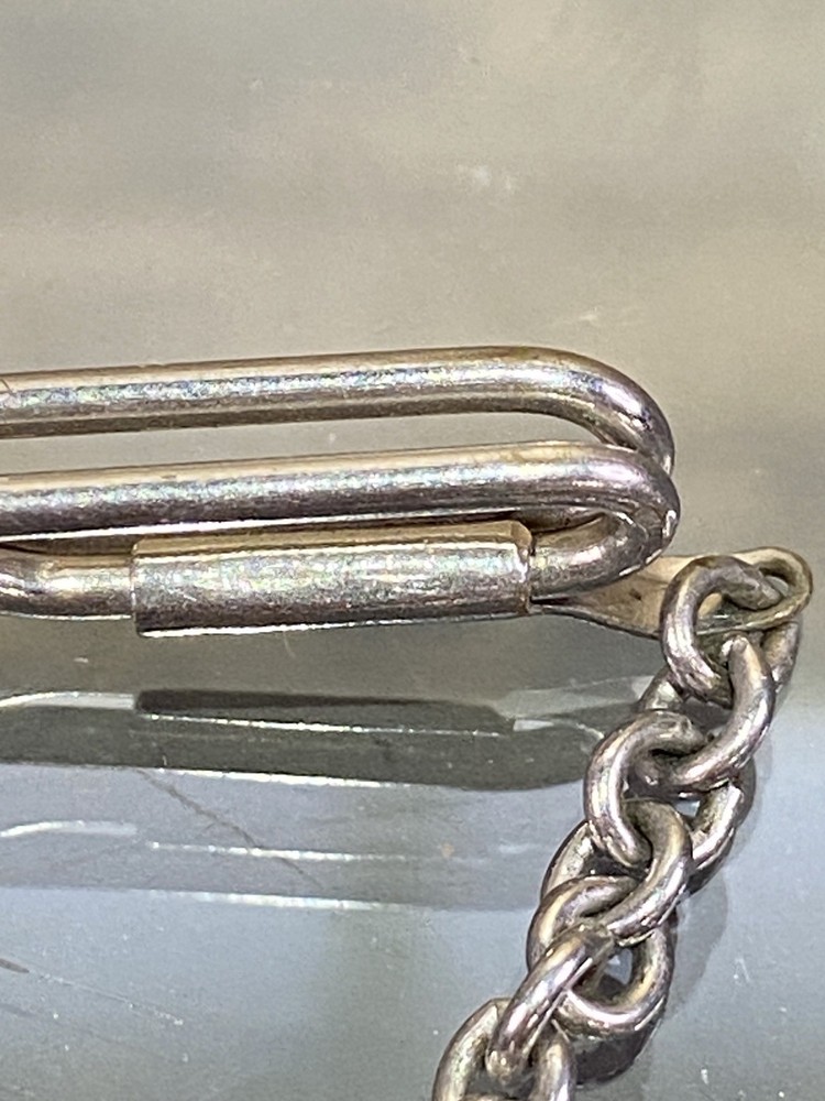 Two Tie Clips, One Marked Anson