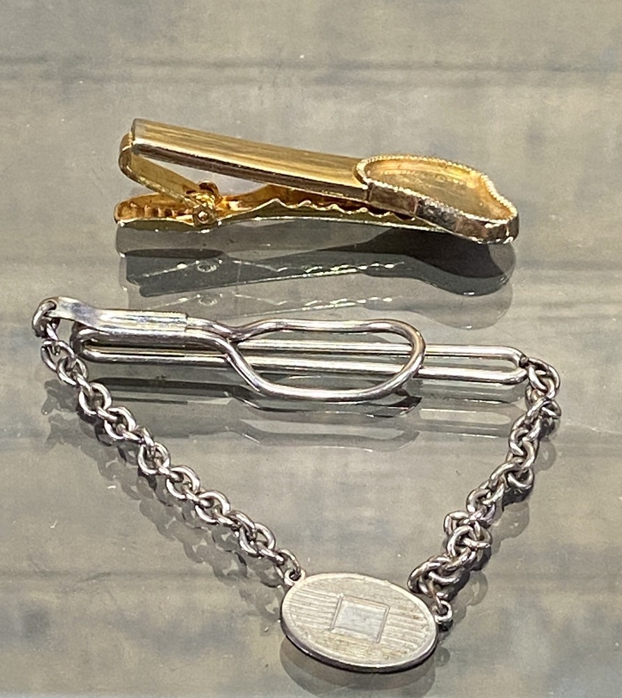 Two Tie Clips, One Marked Anson