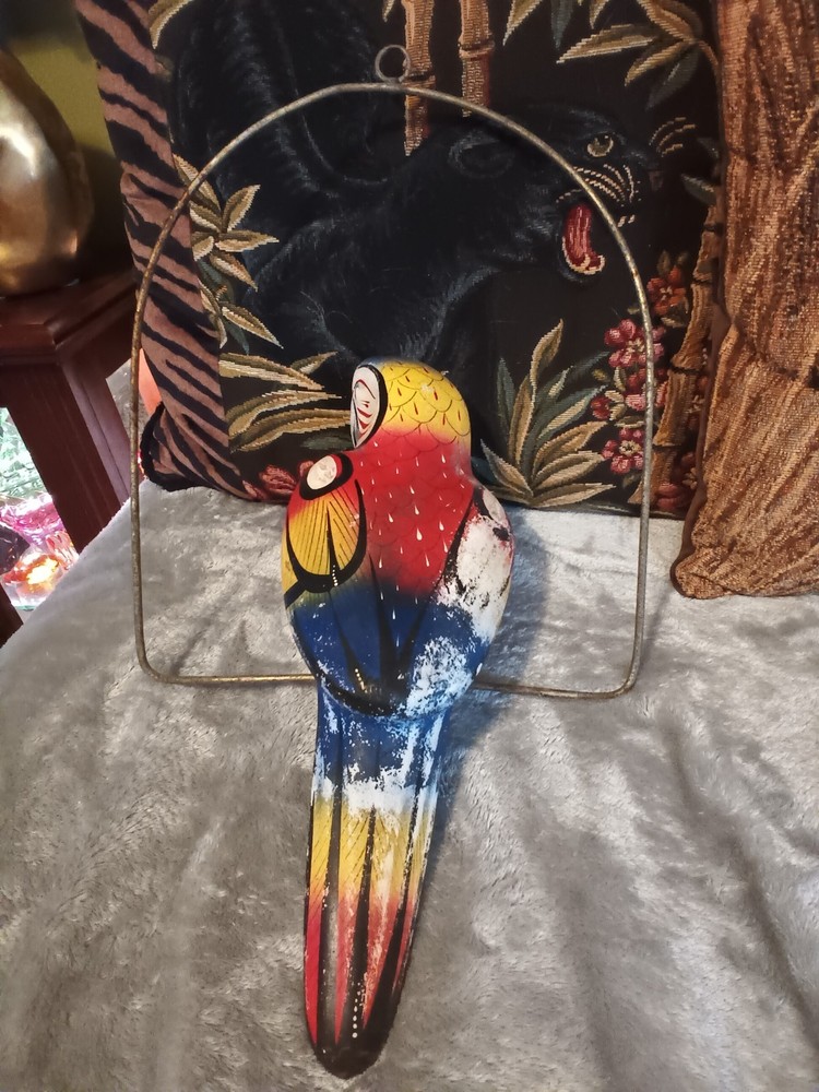 Worn painted ceramic parrot on metal perch,ceiling hanger.