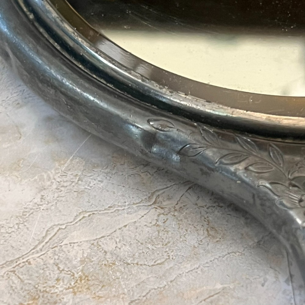 Silver Plated Hand Held Mirror with Intricate Raised Floral Scrollwork