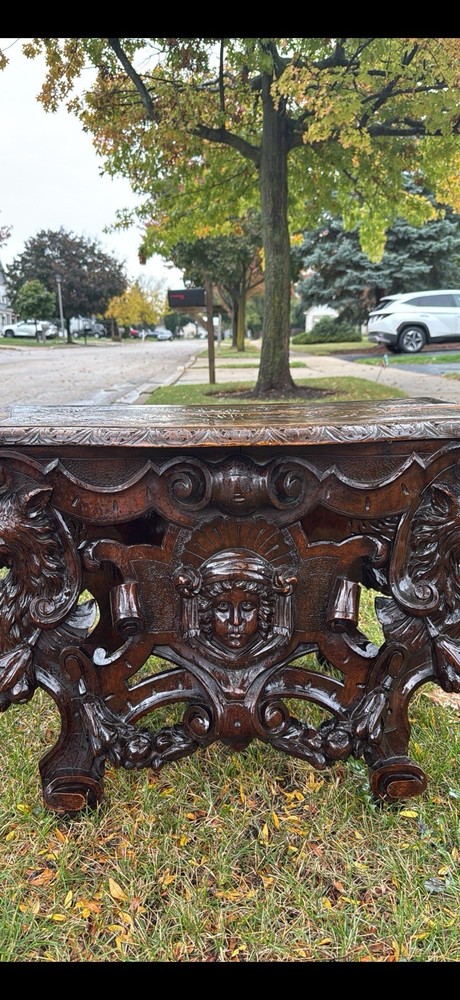 Carved walnut Renaissance Revival center table with ornate figural base. 19th
