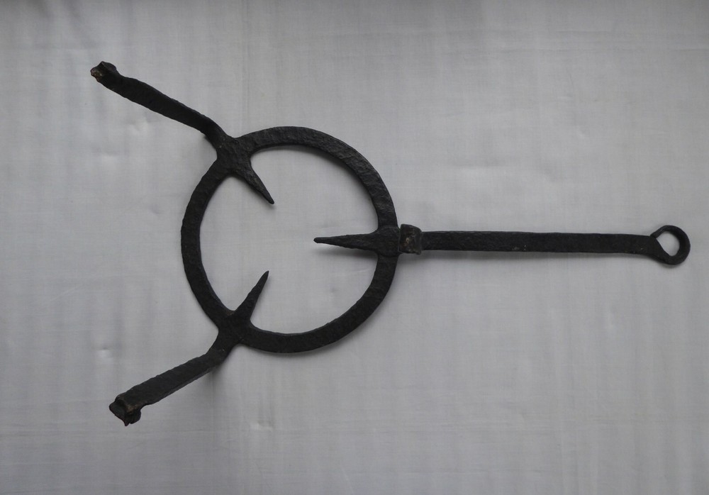 A 18TH CENTURY PRMATIVE FORGED IRON TRIVET
