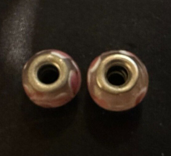 two matching pink patterned charms For Charm Braeclets