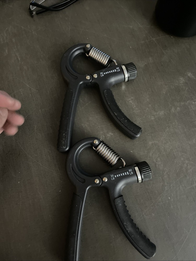 Two Handheld grip strength trainers - black - grey