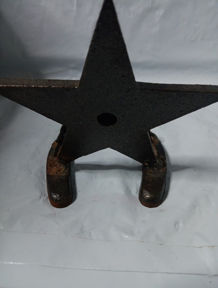 rustic, cast iron desk item featuring a horseshoe base and a large, five-pointed
