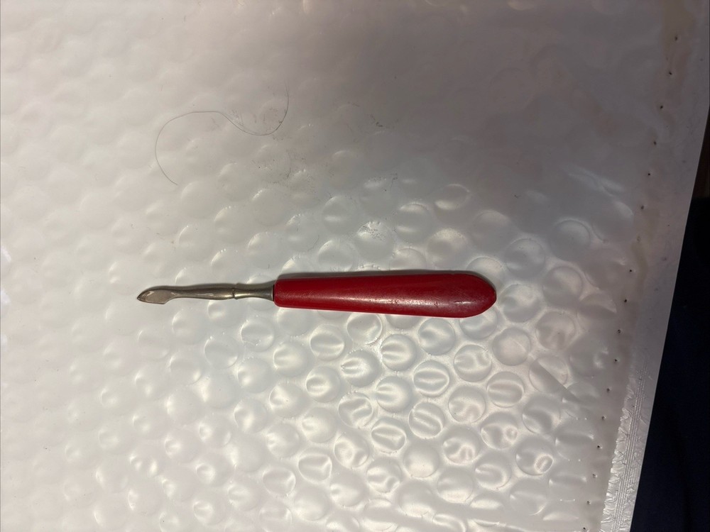 Scalpel handle with a red plastic grip
