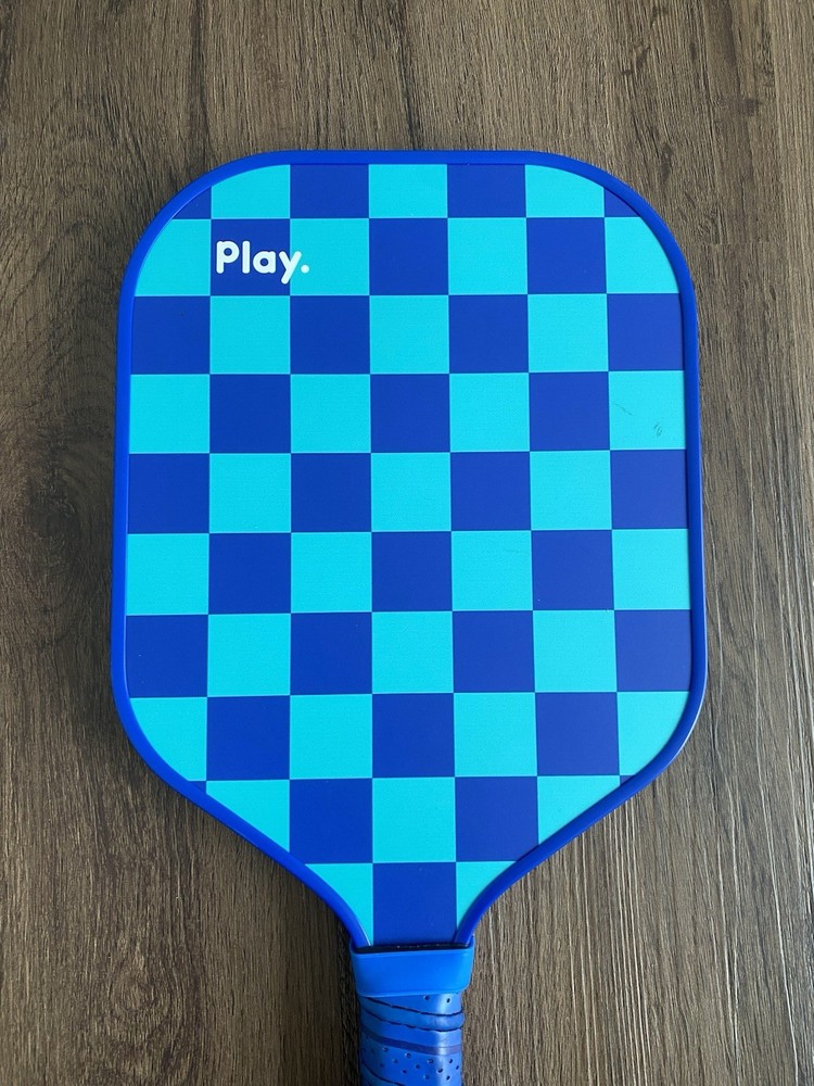Play. Blue Pickleball Paddle Checkered Pattern Has Slight Wear On Handle