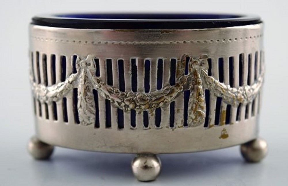 Three Danish salt jars in silver with blue glass inserts and salt spoons.