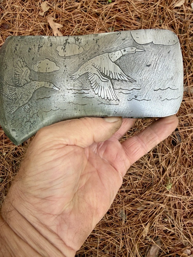 Single Bit Axe With A Duck Scenery Etched On Both Sides.