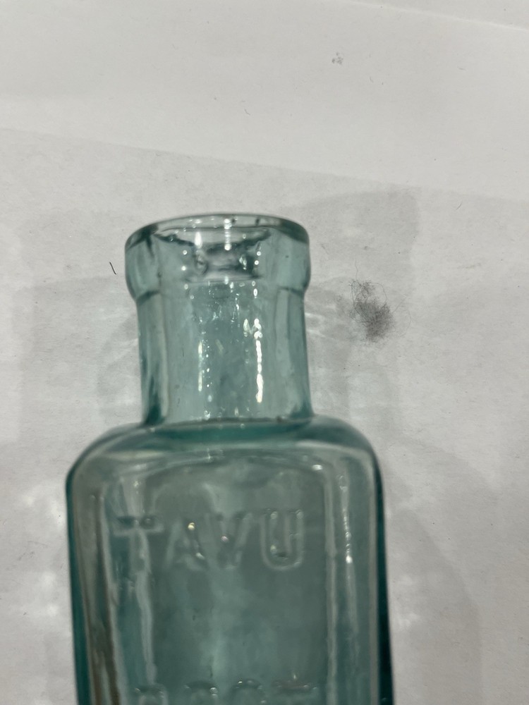 Embossed Aqua Kavu Boot Polish Bottle
