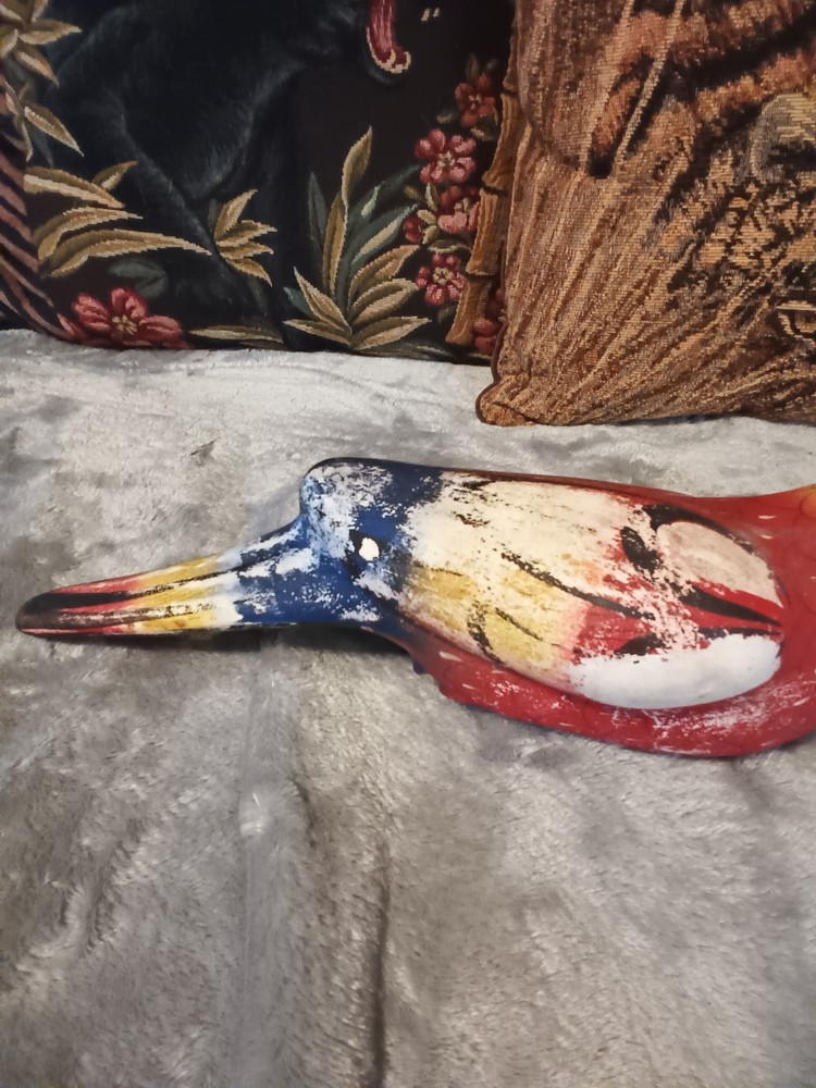 Worn painted ceramic parrot on metal perch,ceiling hanger.