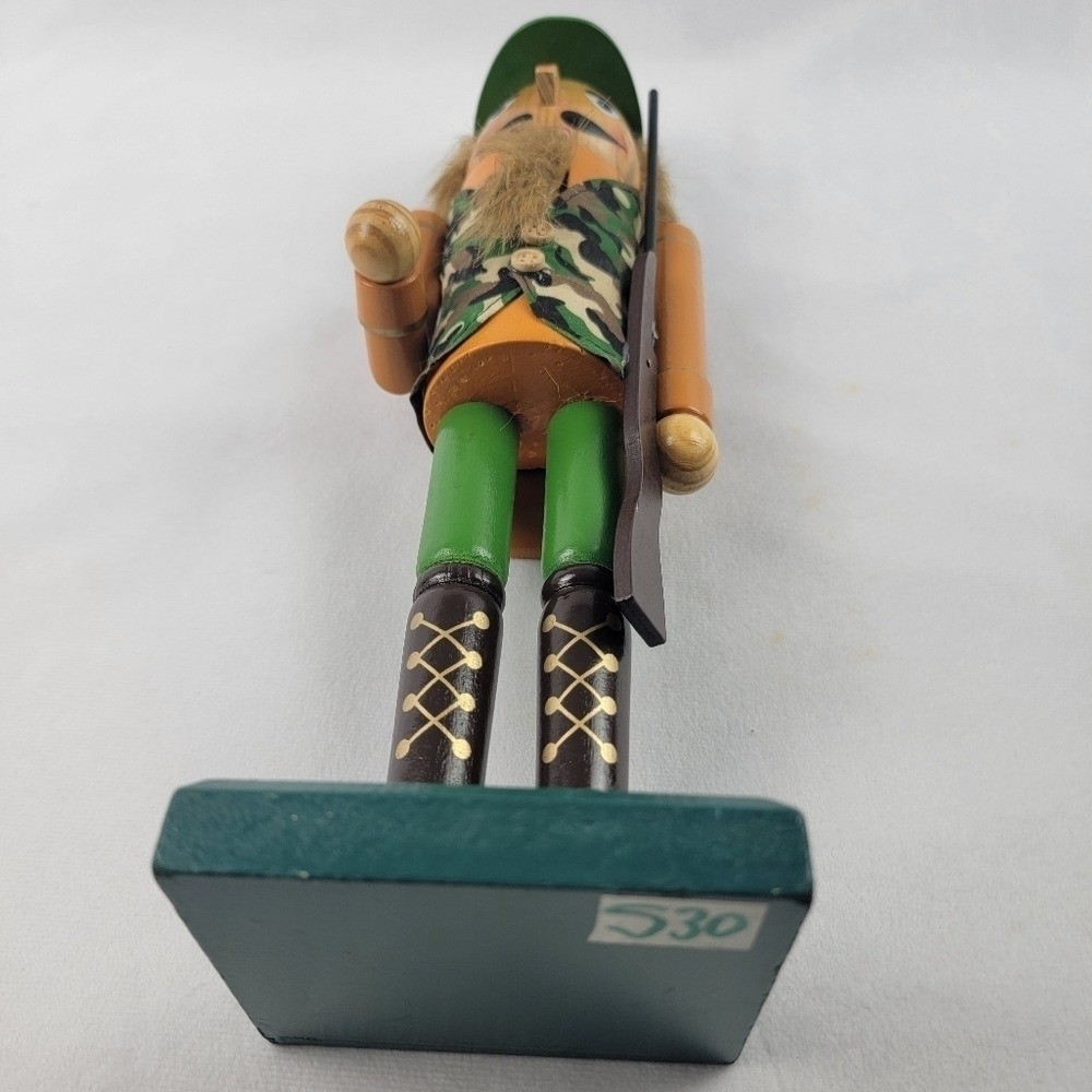 Wooden camouflage nutcracker with a rifle