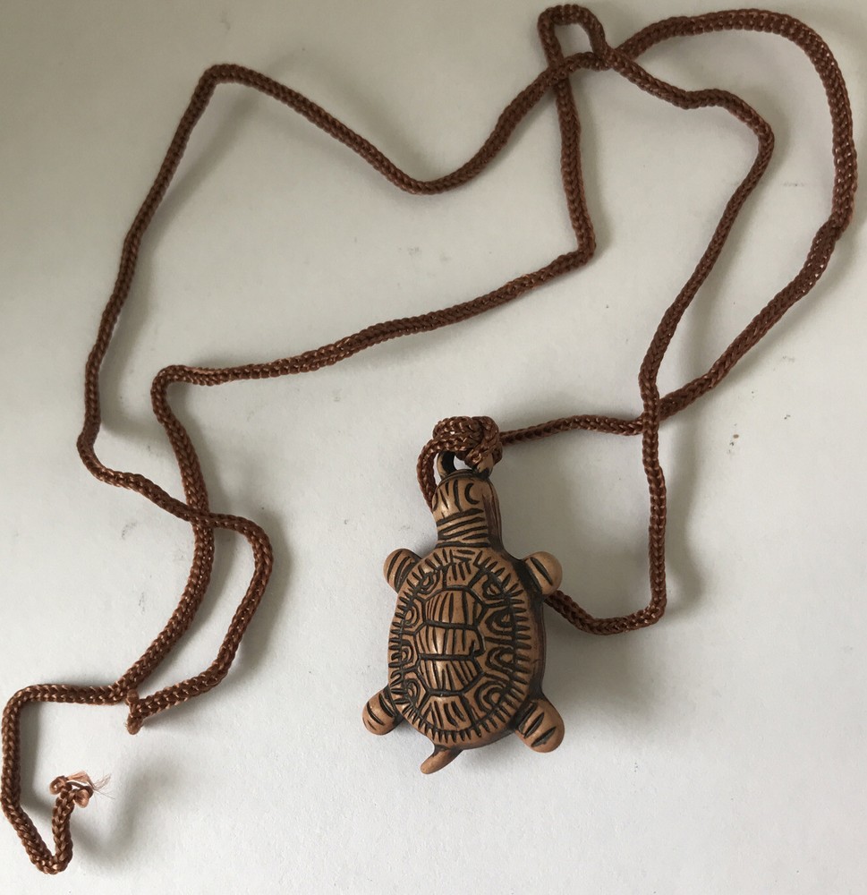 Resin turtle pendant with adjustable rope chain.