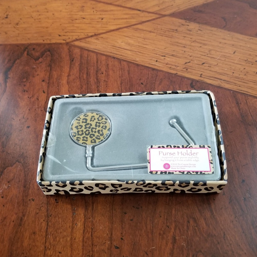 new purse holder hangs purse from table edge.