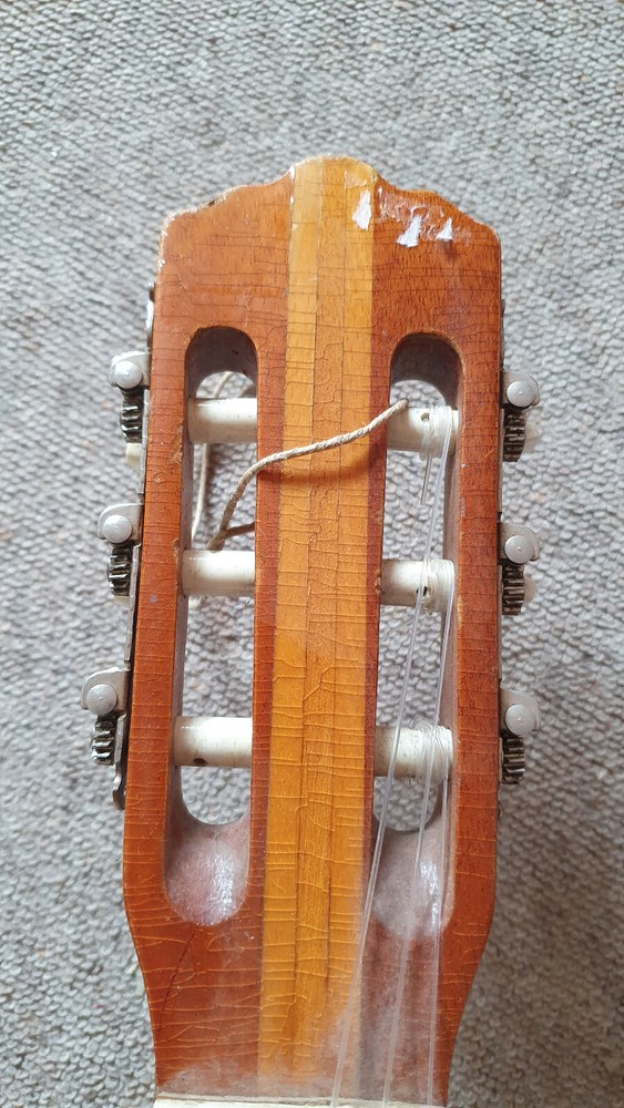 Old guitar with a nicely flamed back, needs service