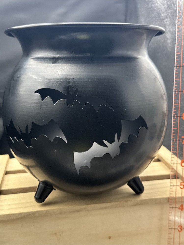 Metal  Cauldron Has Bats Cut Out .