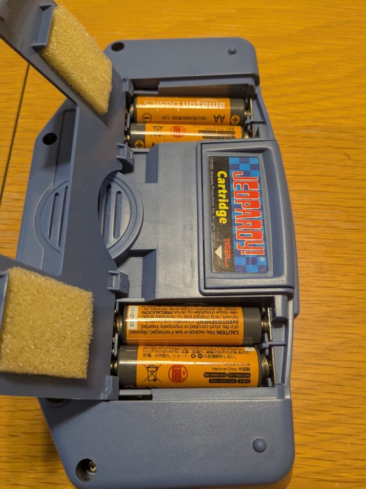 Tiger Electronics Jeopardy Hand Held Game 1995 with Answer Question Book