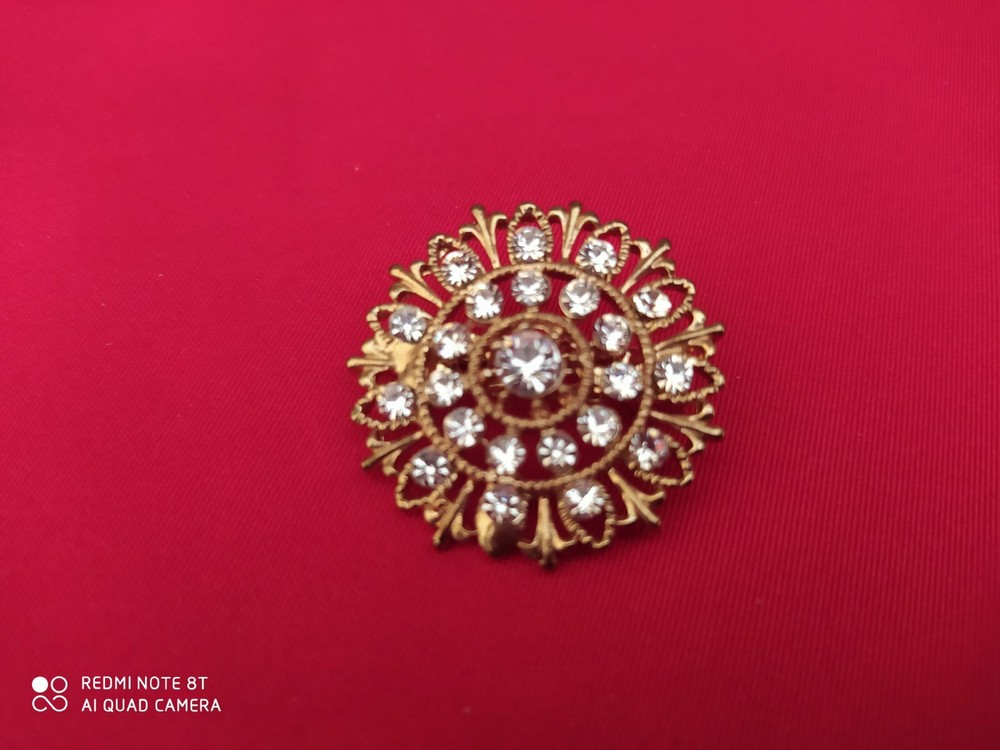 Base metal brooch with stones