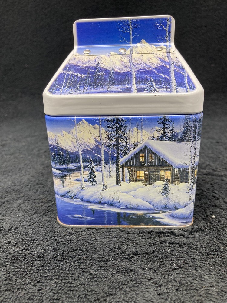 Winter mountain cabin scene tin