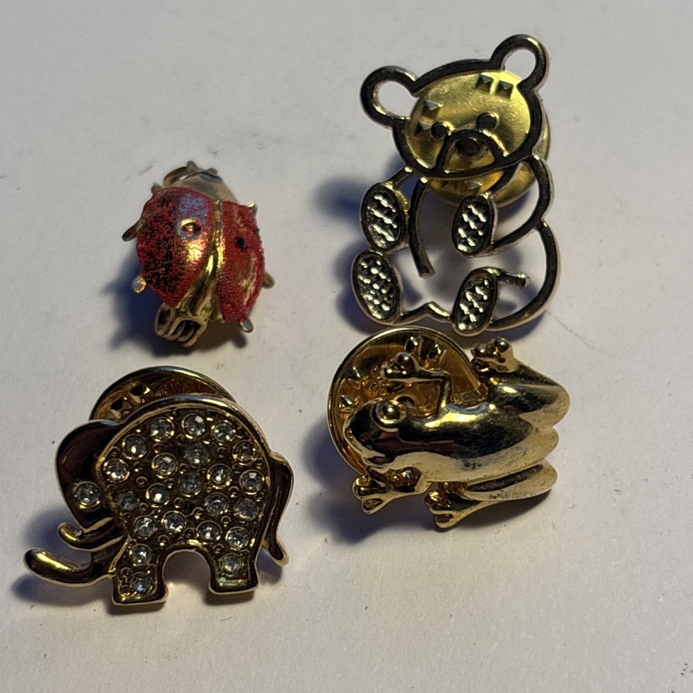 Four Metal Badges.