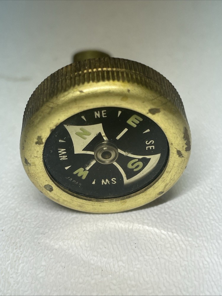 Vintage brass pin on compass