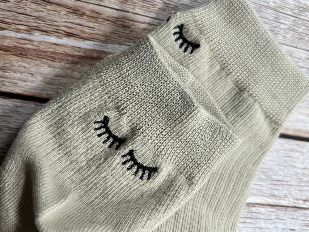 Socks with embroidered lashes