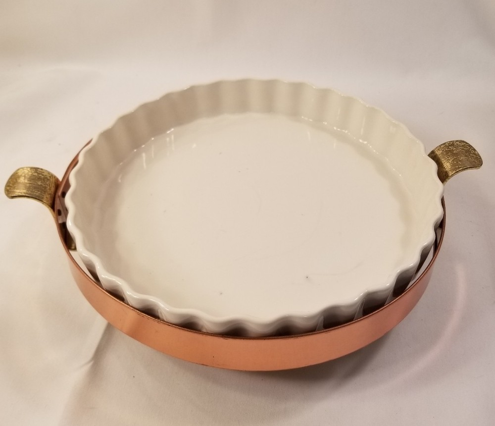Copper and brass dish holder includes white ruffled dish
