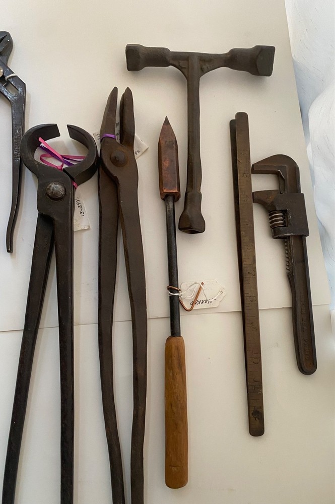 Collection of vintage blacksmithing and farrier tools
