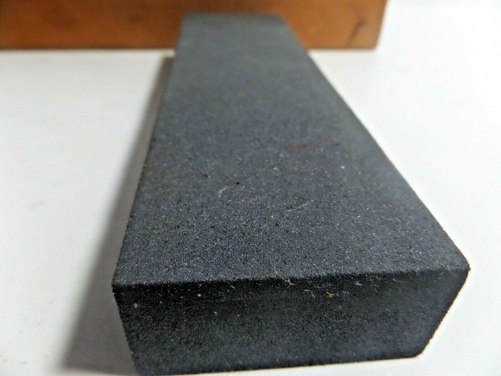 sharpening stone mounted on wood base